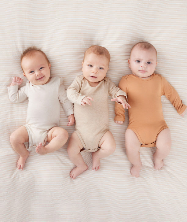 Cozy baby bodysuits from ergoPouch's layer range, made from organic, skin-friendly materials for optimal breathability and comfort.