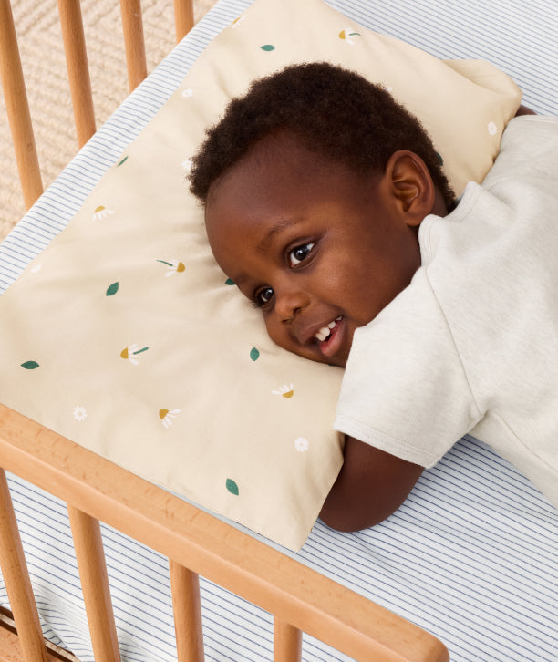 Happy child embracing the toddler pillow