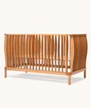 Wooden cot with a modern design on a white background