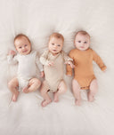 3 Babies Wearing ergoPouch Bodysuit