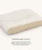 A cross-section diagram of a white pillow showing its internal organic cotton filling, with text below reading 