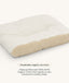 A cross-section diagram of a white pillow showing its internal organic cotton filling, with text below reading 