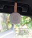 A lightweight, circular Drift Away White Nosie machine suspended by a food-grade silicone strap attached to a car handle. Text overlay titled 