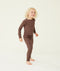 A preschooler standing against a cream background wearing a brown long sleeve pyjama set with matching pants, designed for everyday comfort.
