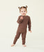 Toddler standing against a cream background wearing a brown long-sleeve pyjama set with matching pants, shown in a relaxed pose.