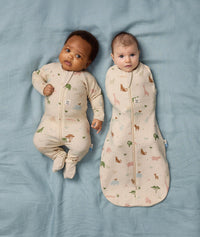 Two babies lying side by side wearing Safari-themed Long Sleeve Layer and Cocoon Swaddle Bag.