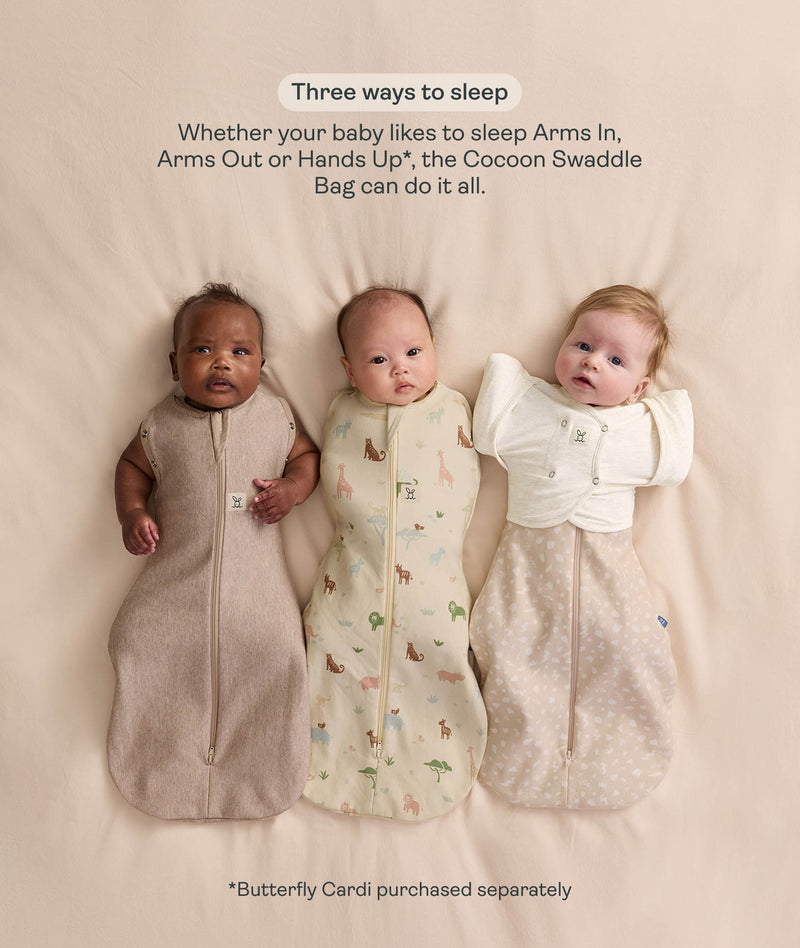 Three babies lying side-by-side demonstrating the three ways to wear the Cocoon Swaddle Bag: Arms Out, Arms In, and Hands Up with a Butterfly Cardi overlay.