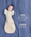 Baby wearing a Cocoon Swaddle Bag layered with a cream 