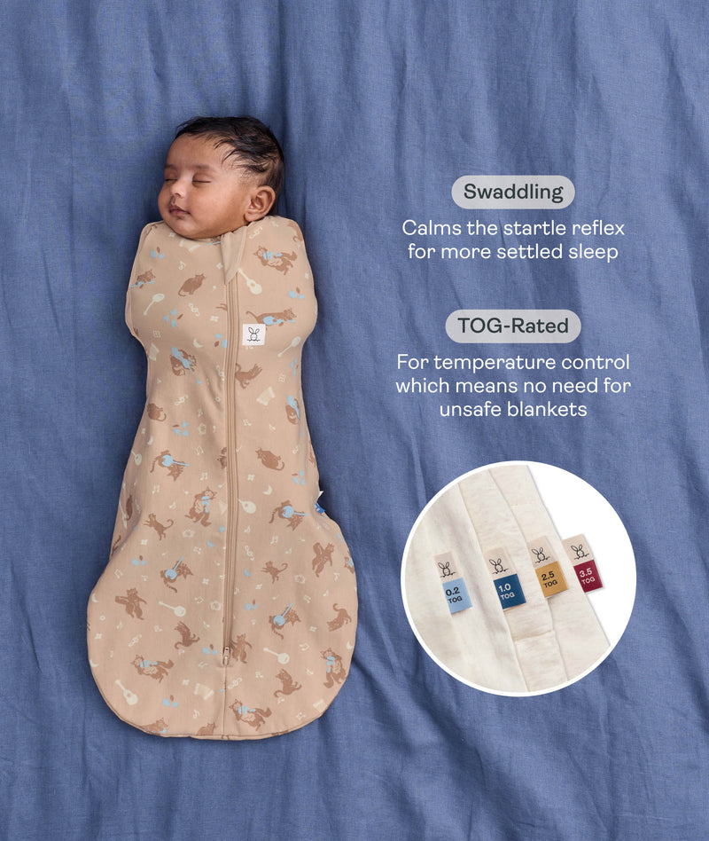 Sleeping baby in a Cocoon Swaddle Bag with text callouts highlighting swaddling benefit and TOG rating feature.