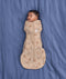 Sleeping baby lying on a blue sheet background, wearing an ergoPouch Cocoon Swaddle Bag 1.0 TOG made from soft, organic cotton.