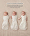 Three side-by-side images showing a baby demonstrating how to transition an ergoPouch Cocoon swaddle Bag into an arms-out Sleep Bag.