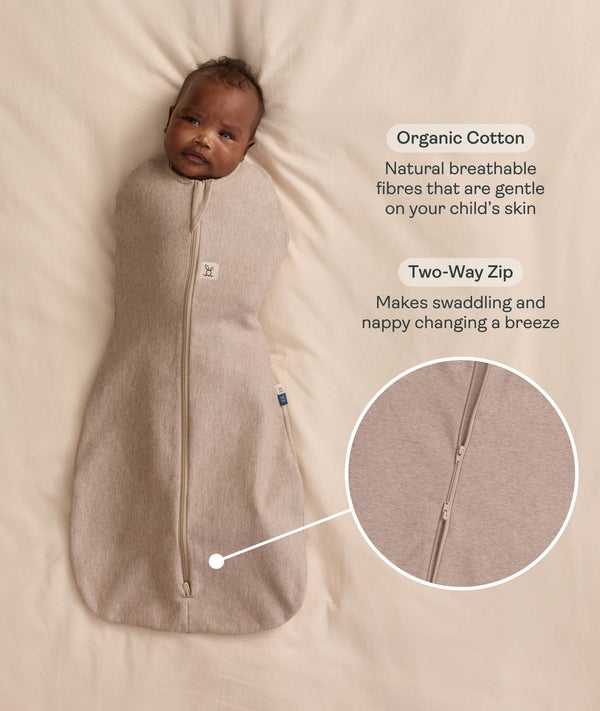 Baby swaddled in a Cocoon Swaddle Bag in Taupe Marle with callouts highlighting 
