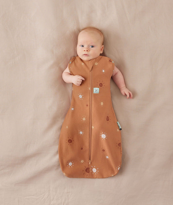 Baby wearing a Cocoon Swaddle Bag 1.0T with its arms out