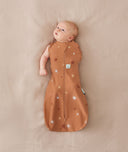 Baby wearing a Cocoon swaddle Bag 1.0T with one arm out