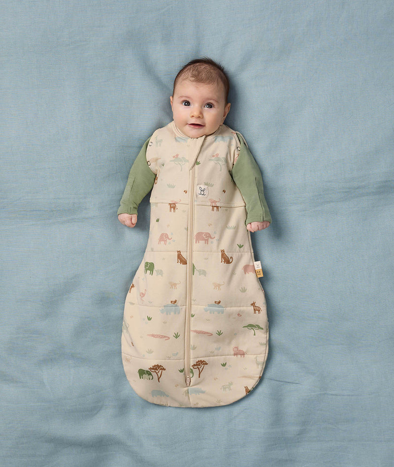 Baby wearing a Safari-themed Cocoon Swaddle Bag with a Long Sleeve Layer underneath.
