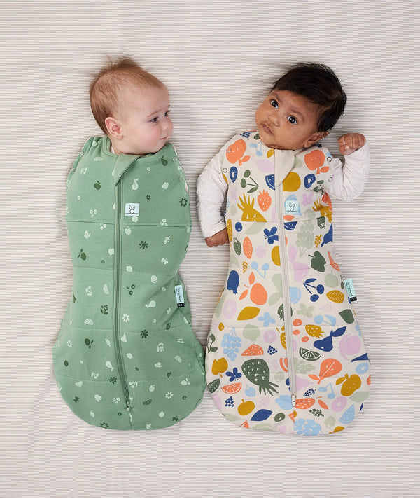 Two babies wearing Cocoon swaddle Bag 2.5 TOG Tutti Fruity collection