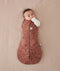 Baby is snugly wrapped in a Cocoon Swaddle Bag with its one arm out