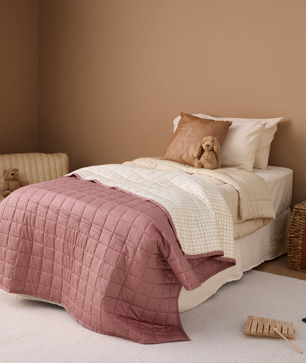 Single bed with convertible quilt and Rosy Gingham coverlet