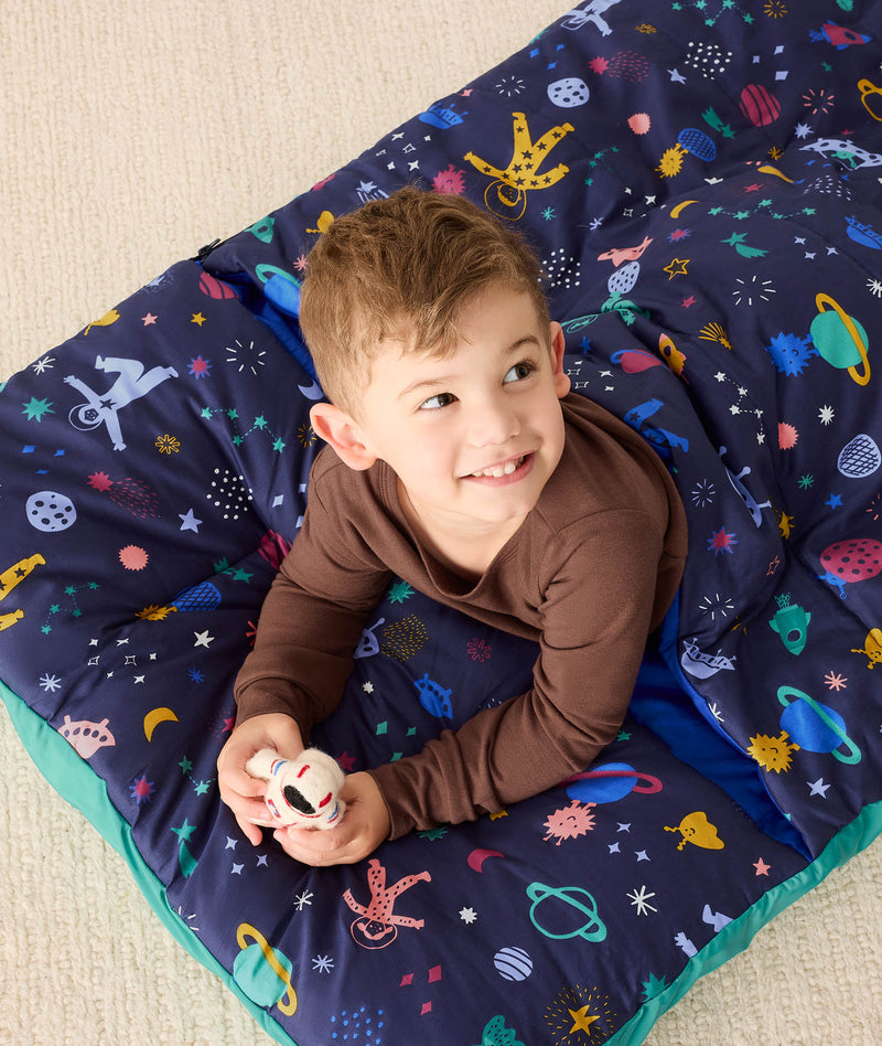 DreamRoll All-in-One Sleep Mat Space Dreams preschooler lying on tummy