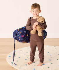 DreamRoll All-in-One Sleep Mat Space Dreams preschooler standing wearing carry bag 
