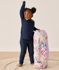 DreamRoll All-in-One Sleep Mat Unicorn Dreams holding carry bag