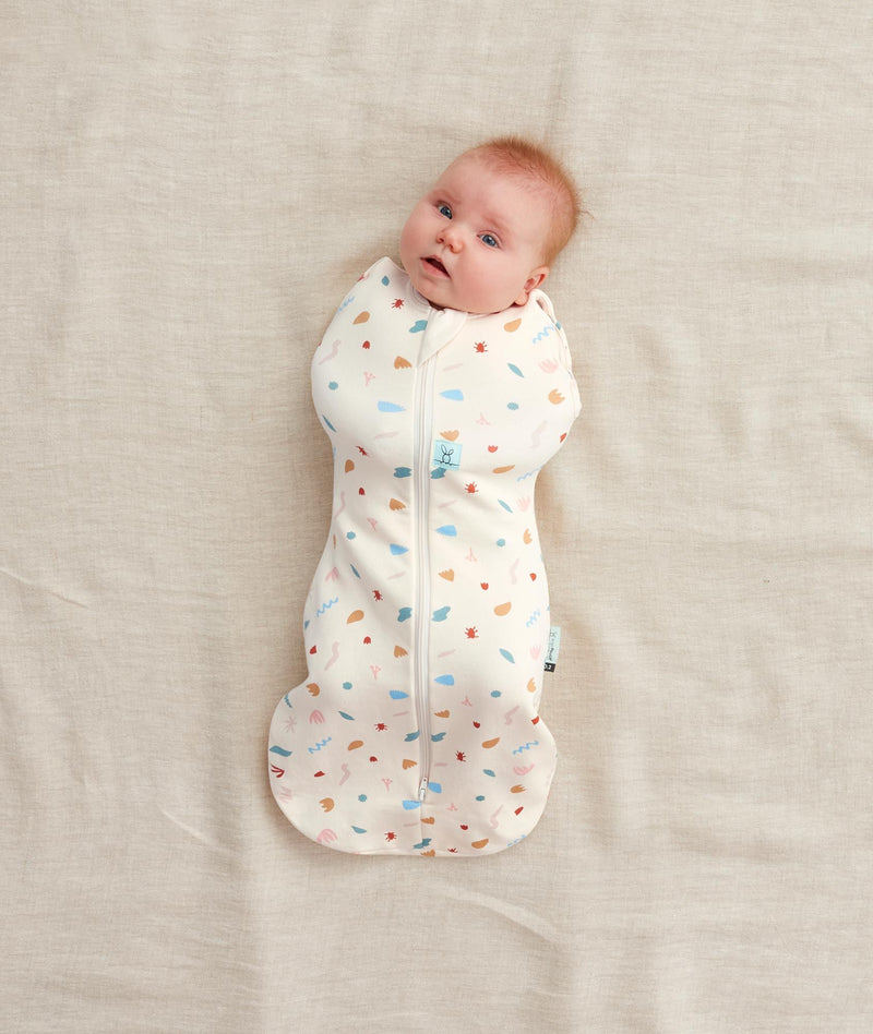 Baby swaddled in  0.2 TOG Cocoon Swaddle Bag Desert Bloom