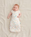 Baby wearing a 0.2 TOG Cocoon Swaddle Bag with its arms out