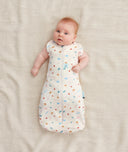 Baby wearing a Cocoon Swaddle Bag 1.0 TOG with its arms out