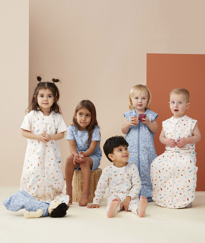 Group of kids and toddlers, all wearing ergoPouch Sleepwear