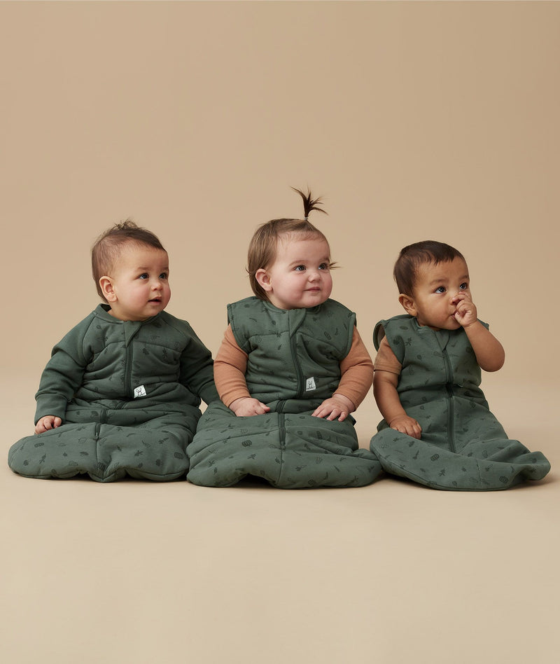 Three infants wearing ergoPouch Sleeping Bags in 3.5 TOG with sleeves, 2.5 TOG, and 1.0 TOG