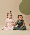 Two infants wearing ergoPouch Sleeping Bag 1.0 TOG