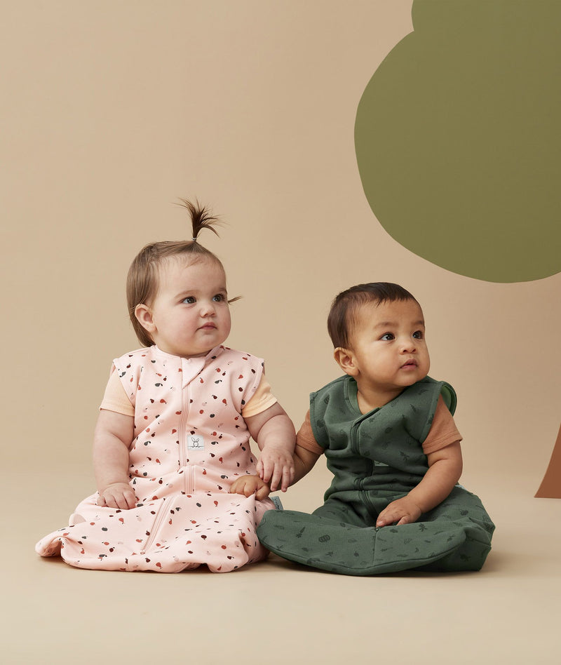 Two infants wearing ergoPouch Sleeping Bag 1.0 TOG