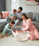Easy Sleep Portable Bassinet Ecru family sitting in living room