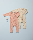 Two long-sleeve baby sleepwear laid flat on a light blue background in Elephant Parade and Savannah.
