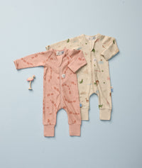 Two long-sleeve baby sleepwear laid flat on a light blue background in Elephant Parade and Savannah.