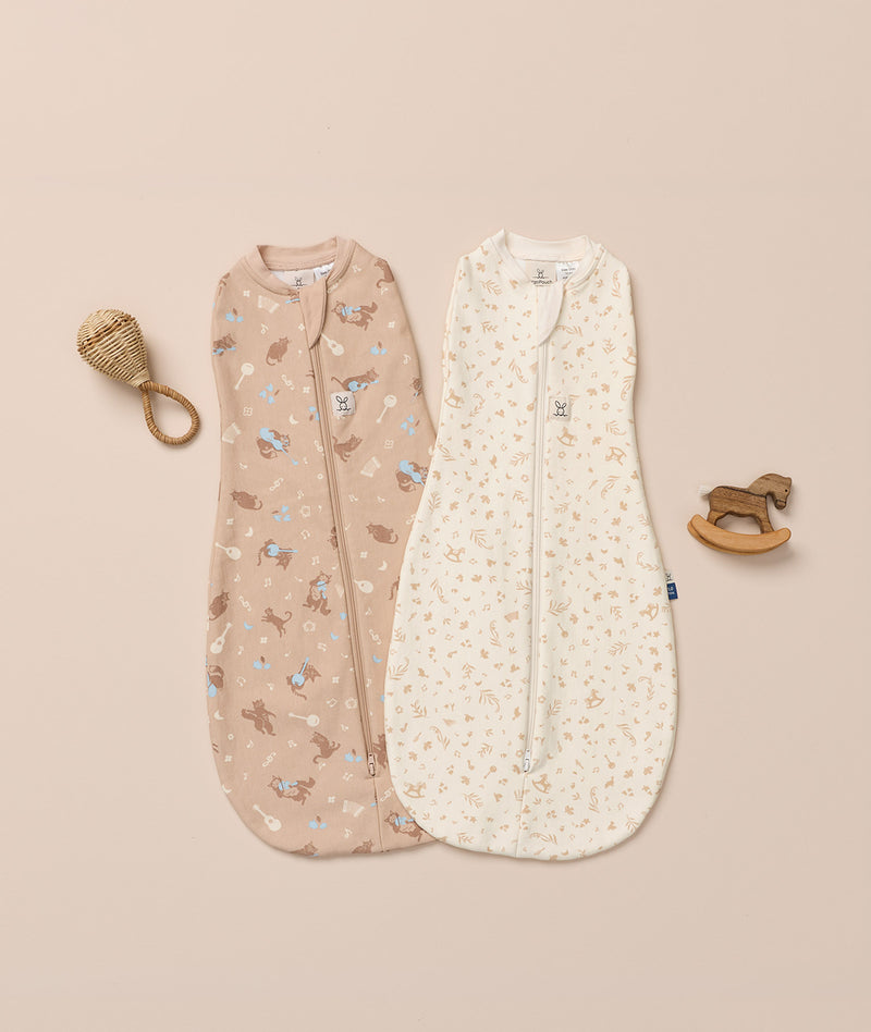 Flatlay of ergoPouch Cocoon Swaddle Bags in Lullaby and Melody