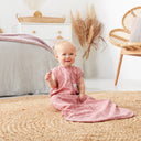 Infant sitting on rug wearing a jersey sleeping bag 1.0 TOG
