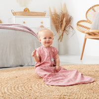 Infant sitting on rug wearing a jersey sleeping bag 1.0 TOG