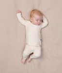 Sleeping baby wearing an ergoPouch Long Sleeve Baby Pyjamas
