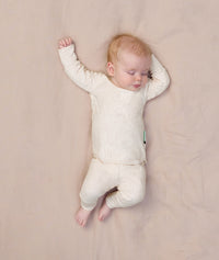 Sleeping baby wearing an ergoPouch Long Sleeve Baby Pyjamas