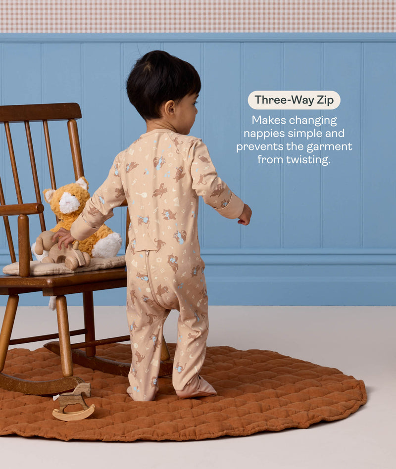 Back view of a toddler wearing a beige patterned Long Sleeve Layer with a text callout highlighting a 