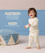 Happy toddler wearing ergoPouch Long Sleeve Pyjamas with text highlight on GOTS organic cotton and TOG rating