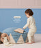 Toddler in cream Long Sleeve Pyjamas with subtle print, featuring a drop hem feature callout.