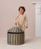 Preschooler wearing a beige printed Long Sleeve Pyjama set opening a striped woven storage basket.