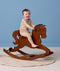 Toddler in patterned beige Long Sleeve Pyjamas riding a wooden rocking horse.