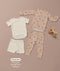 Flat lay of a cream Short Sleeve Pyjama set and a beige Long Sleeve Pyjama set with a wooden toy horse and feature text callout.