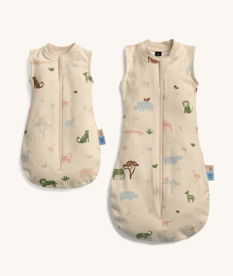 Two doll-sized sleeping bags with a beige base color and a playful safari animal print. Each has a sleeveless design and a front zipper for easy access.