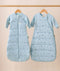 The Jersey Sleeping Bag and Side Zip Sleeping Bag hang side by side on wooden hangers. Both are light blue with small dragonflies pattern; the Jersey Sleeping Bag has a center front zipper, while the Side Zip Sleeping Bag features a diagonal side zipper.