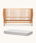 Wooden cot and mattress on a white background
