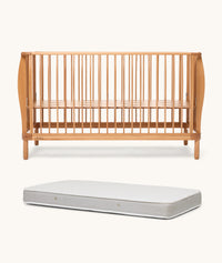 Wooden cot and mattress on a white background